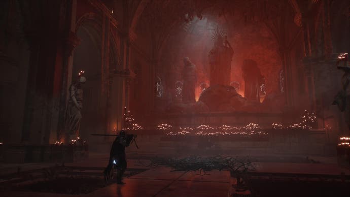 Spielercharakter in Lords of the Fallen vor einem Altar aus Statuen und Kerzen im roten Licht