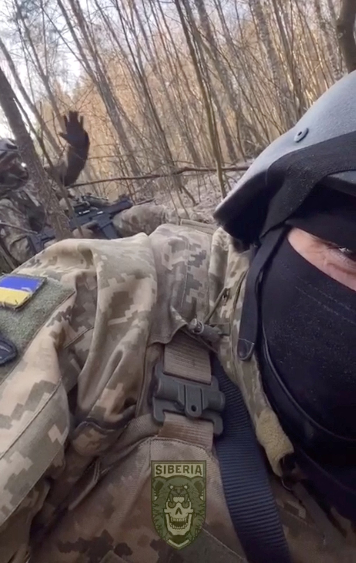 More fighters from the anti-Putin fighting force wave at the camera
