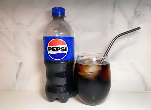 Pepsi-Flasche neben Sodaglas