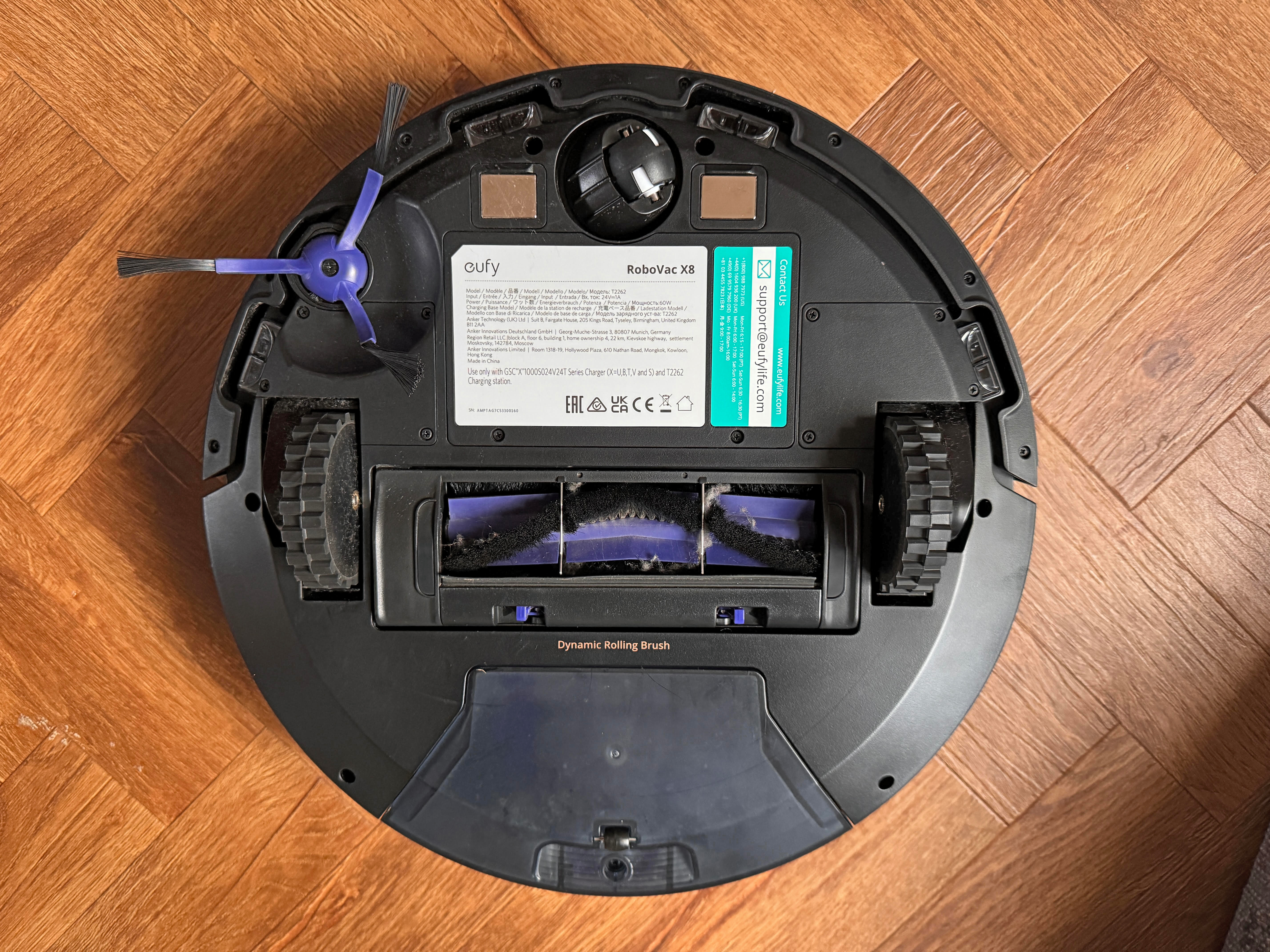 The underside of the Robovac X8 reveals its detachable brush and roller brush