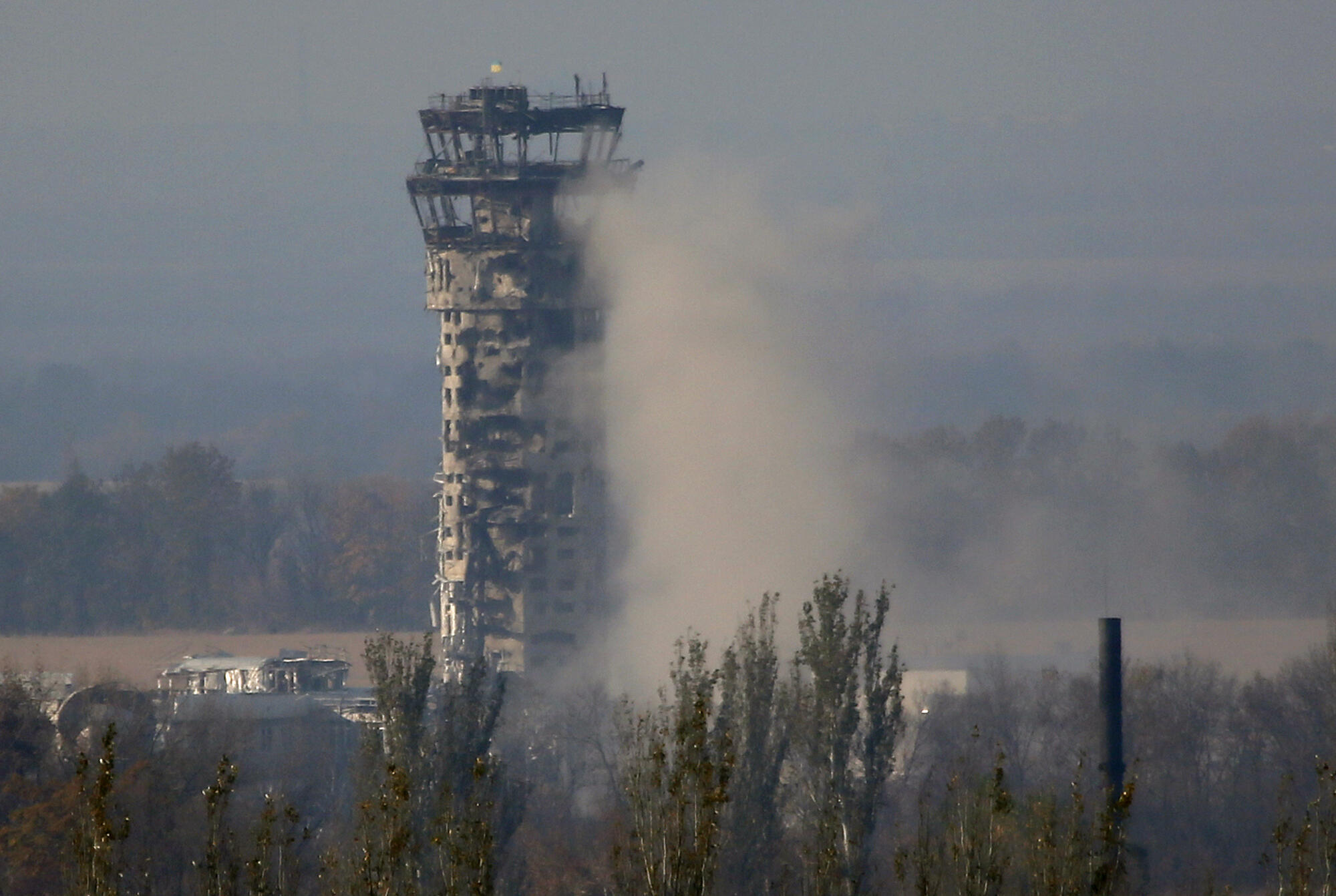 A Ukrainian flag flies over the control tower of Donetsk  International Airport during an artillery battle between pro-Russian rebels and Ukrainian forces in Donetsk, eastern Ukraine,Oct. 17, 2014