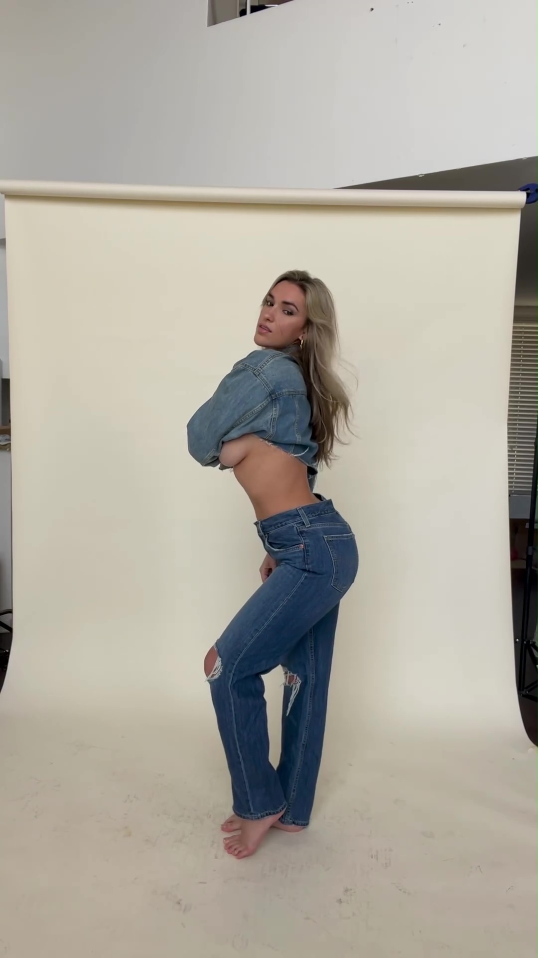 Kayla strahlte in einem Jeans-Crop-Top und Jeans vor der Kamera