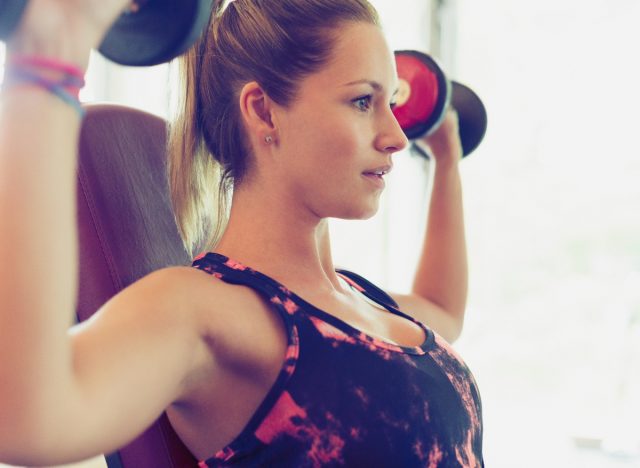 Frau macht Hanteldrücken, Konzept des morgendlichen Trainings, um den Gewichtsverlust zu beschleunigen