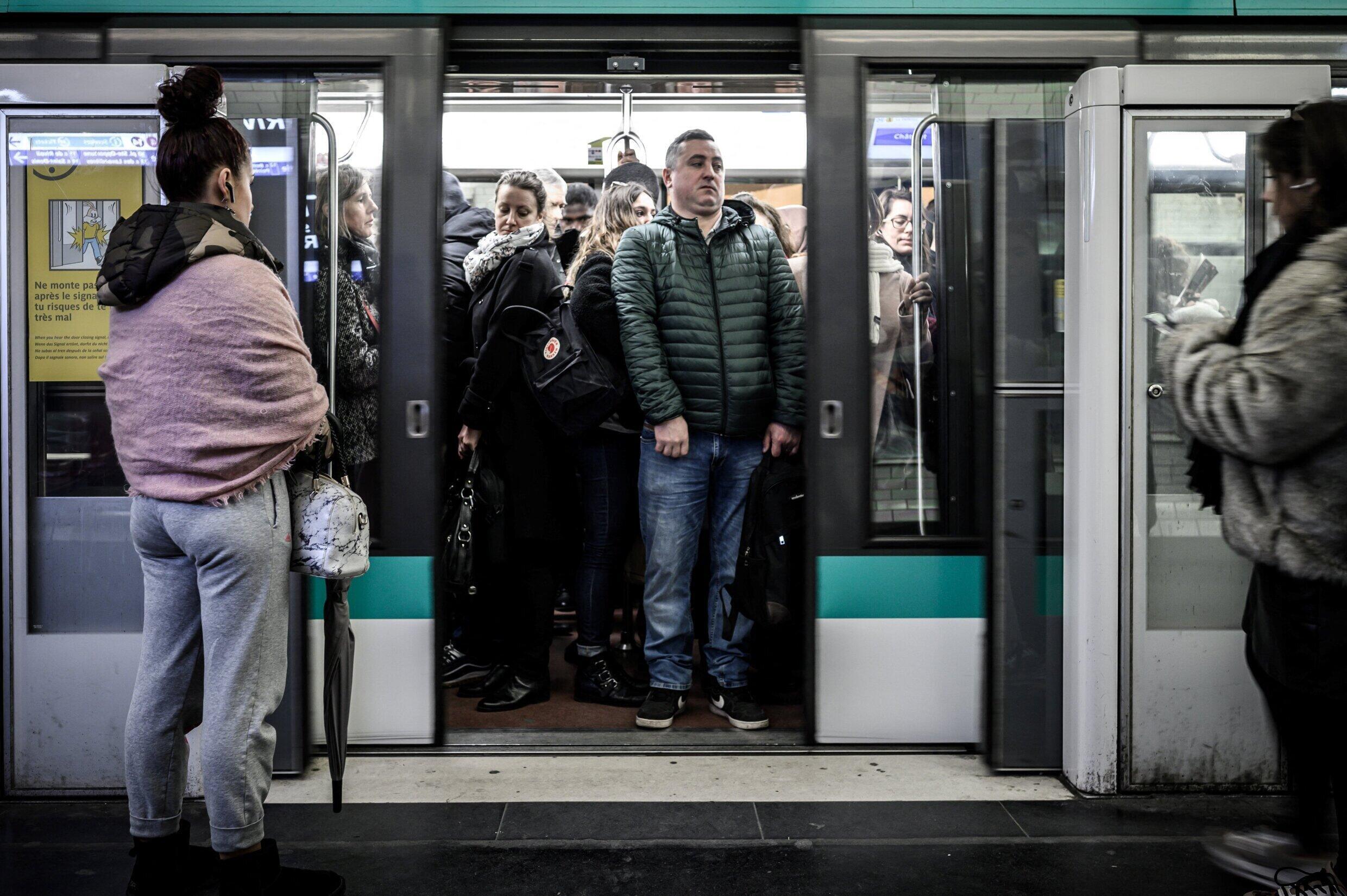 Commuters aboard a train of the subway line 1 which runs through Paris on December 12, 2019 in Paris.
